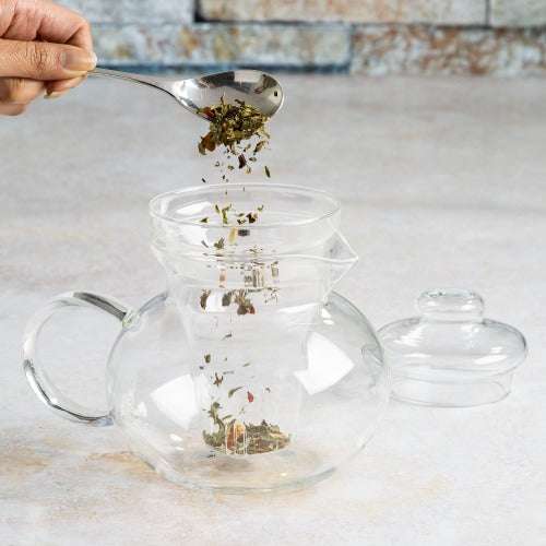 Blossom Teapot adding loose tea on counter