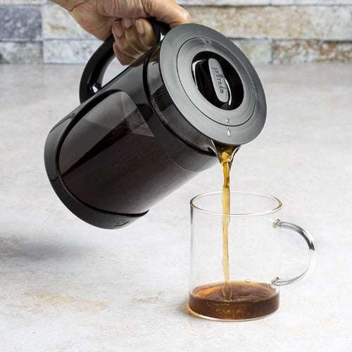 Pouring a mug of coffee from a primula burke cold brew pitcher