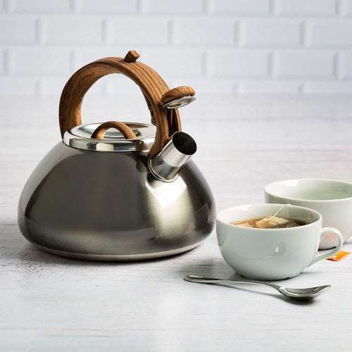 Avalon Whistling Kettle on table next to cup of tea