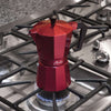 Red Espresso Maker on lit gas cooktop